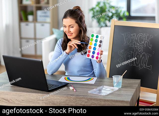 teacher with colors having online class of arts