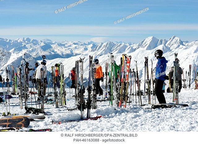 Tourists stand next to skis on the 2, 900 meter high Eggishorn on a sunny day in Fiesch, Germany, 06 February 2014. Photo: RALF HIRSCHBERGER | usage worldwide
