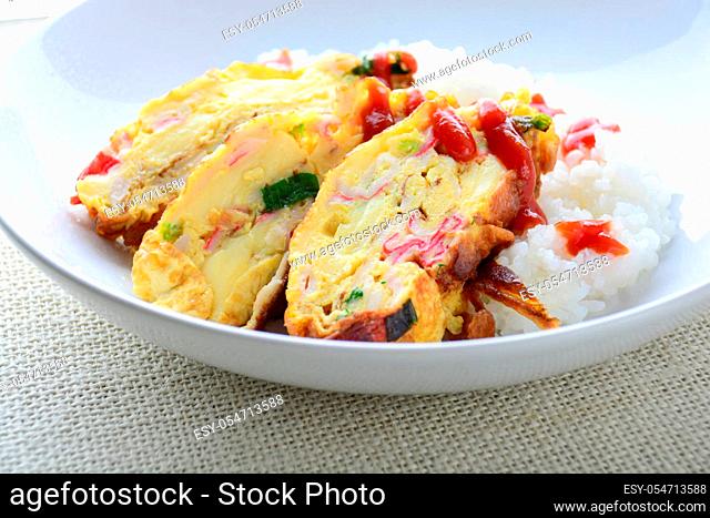 Sliced omelette with soft tofu, crab stick and spring onion with rice on dish