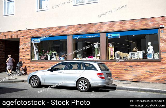 19 June 2021, North Rhine-Westphalia, Essen: A woman walks past the social department store that has opened in the former Aldi headquarters