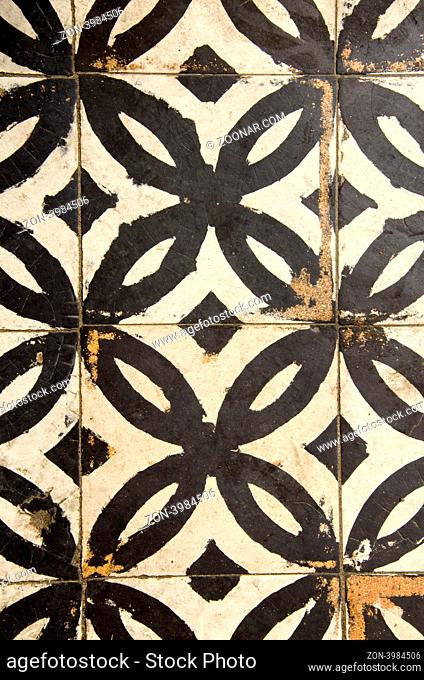 Antique floor tiles abraded backdrop in corridor