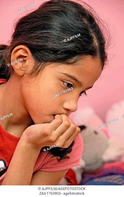 Nervous child  Young girl biting her finger nails