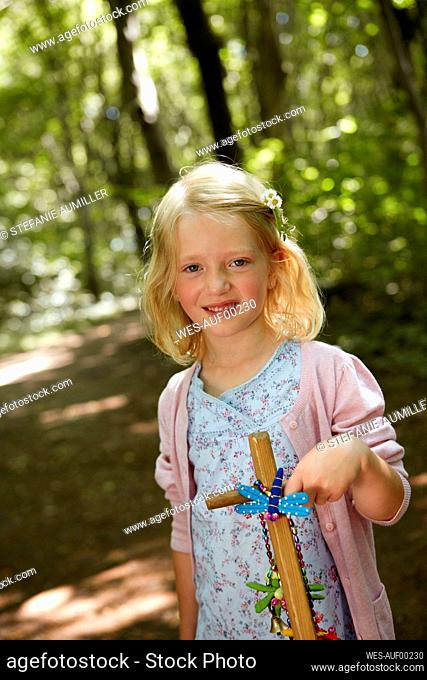 Portrait of a girl with hand cart in forest