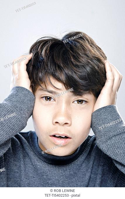 Portrait of boy 12-13 expressing stress