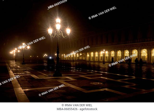 St Mark's Square / Piazza San Marco in Venice in the evening during the Christmas period, atmospheric lighting on the nearly deserted square and in the arcades