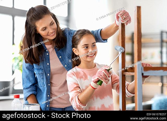 mother and daughter painting old table in grey