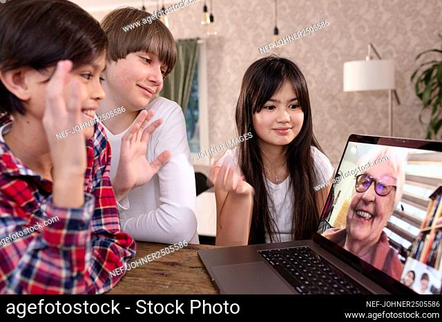 Grandchildren talking to grandmother via video call