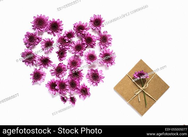 Heart frame pattern with flowers, pink flower buds, on white background isolated from above