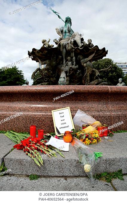 Flowers lie in front of Neptune Fountain in Berlin, Germany, 30 June 2013. A 31 year old man from Berlin was shot and mortally wounded in the same spot by a...