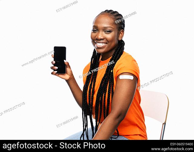 happy vaccinated woman and smartphone