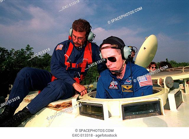 04/27/1999 --- Under the guidance of Capt. Steve Kelly left, with Space Gateway Support, STS-96 Mission Specialist Daniel Barry right practices driving the...