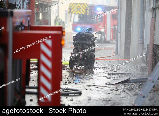 28 February 2021, Thuringia, Ronneburg: Firefighters extinguish a fire in the old town. In the city center of Ronneburg (Greiz district)