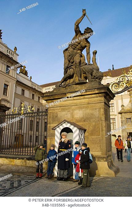 Group of chidren with the guard at castle gate in Hradcany Prague Czech Republic Europe