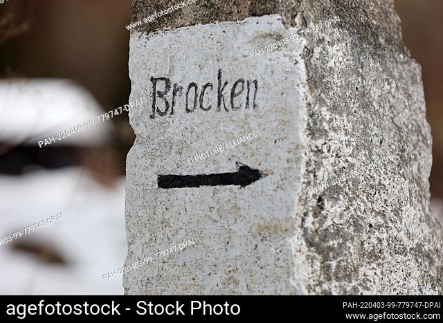 03 April 2022, Saxony-Anhalt, Ilsenburg: View of a stone with the inscription Brocken. The excursion destination at Scharfenstein below the Brocken is very...