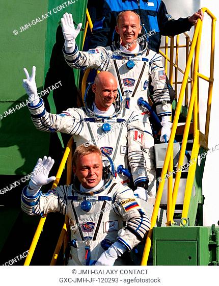 NASA astronaut Jeffrey Williams (top), Expedition 21 flight engineer; spaceflight participant Guy Laliberté (center) and Russian cosmonaut Maxim Suraev