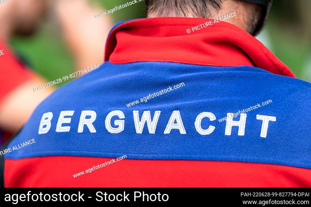 27 June 2022, Baden-Wuerttemberg, Waldkirch: The lettering ""Bergwacht"" can be seen on the jacket of a member of the Waldkirch mountain rescue team during...
