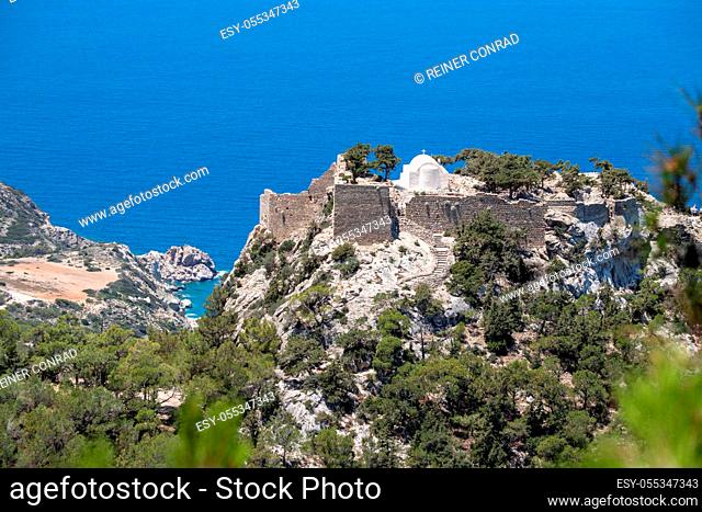 Panoramic view at landscape and coastline near Monolithos on Greek island Rhodes with the aegaen sea in the background and old ruins with church on a hill