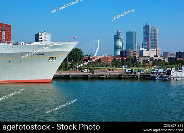 ROTTERDAM - SEPTEMBER 17, 2014: Harborside view with SS Rotterdam in the foreground and Rotterdam skyline in the background on September 17, 2014 in Rotterdam
