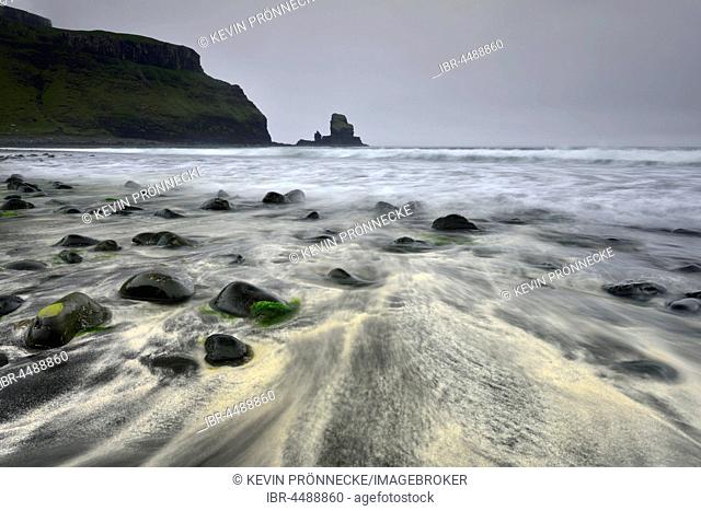 Stones in the sand on the beach of Talisker Bay, cliffs and rocks, Isle of Skye, Scotland, United Kingdom