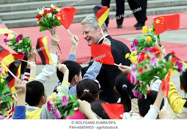 Chinese school children wave flags and flowers during a rehearsal before a welcome ceremony for German President Joachim Gauck at the Great Hall of the People...