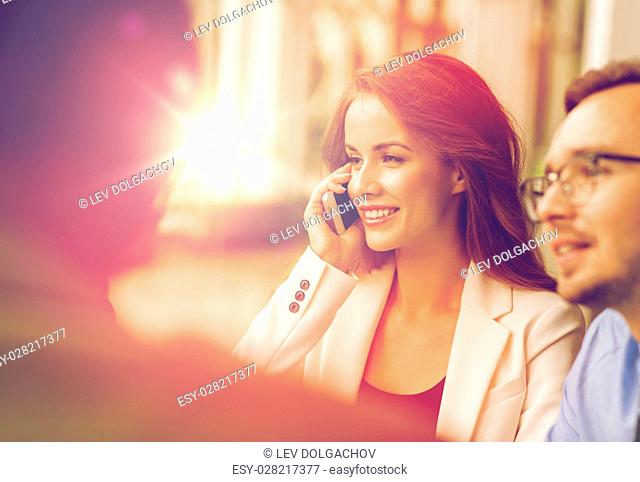 business, technology, communication and people concept - happy businesswoman calling on smartphone at office