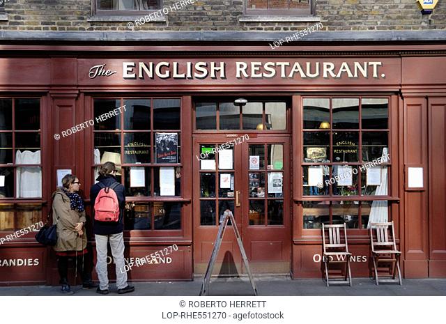 England, London, Spitalfields. People looking at a menu in the window of The English Restaurant, a high class, quintessentially British restaurant in...