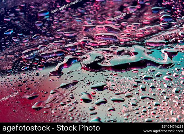Fashionable background with UV effect lighting close-up water droplets. Trendy backdrop for your design