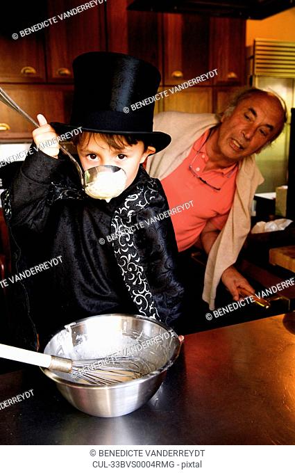 Boy magician tasting his cooking