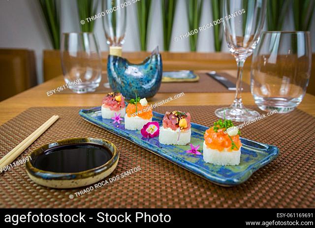 Delicious premium salmon and tuna Oshizushi sushi (Batera sushi) on a decorated handmade porcelain plate