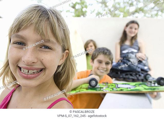 Portrait of a girl smiling with her friends behind her