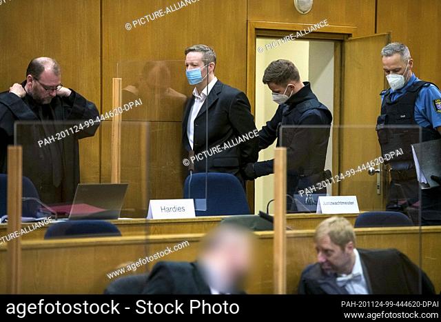 24 November 2020, Hessen, Frankfurt/Main: The main defendant Stephan Ernst (2nd from left, back) is taken to a courtroom at the Higher Regional Court