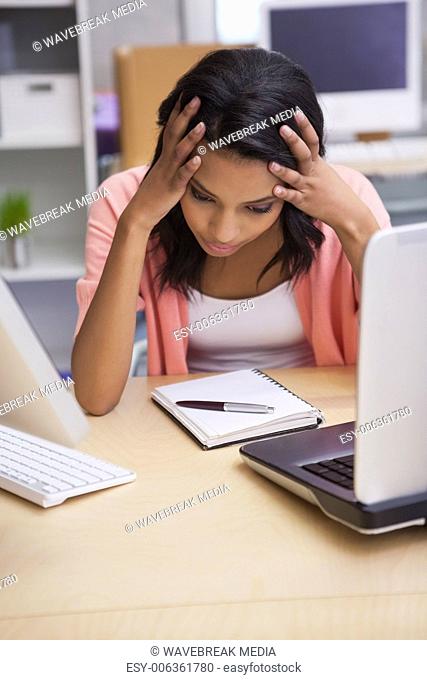 Anxious businesswoman sitting at her desk