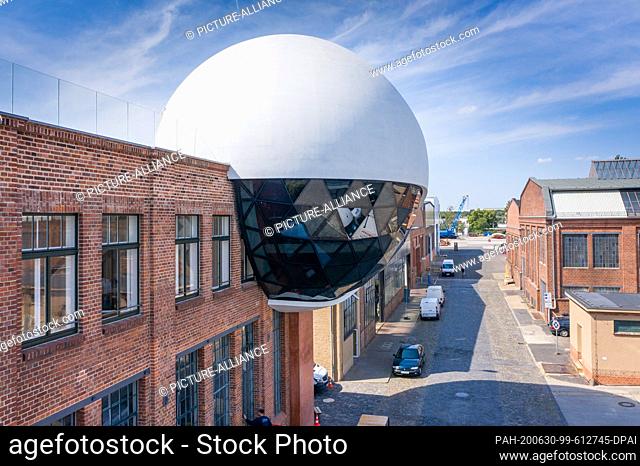 23 June 2020, Saxony, Leipzig: Window cleaners clean the windows of the ""Niemeyer Sphere"" on the premises of the traditional crane manufacturer Kirow