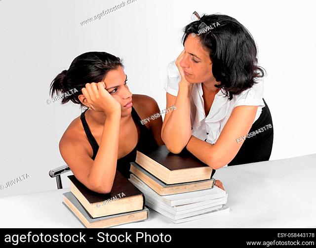 A girl sitting and a woman stand with books looking to each other