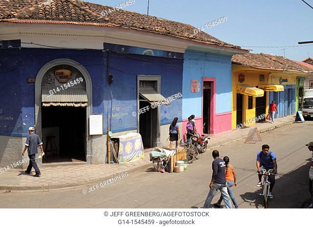 Nicaragua, Granada, Calle Vega, colonial heritage, neighborhood, street scene, corner, building, business, colorful, pedestrian, cyclist, Hispanic, man, woman