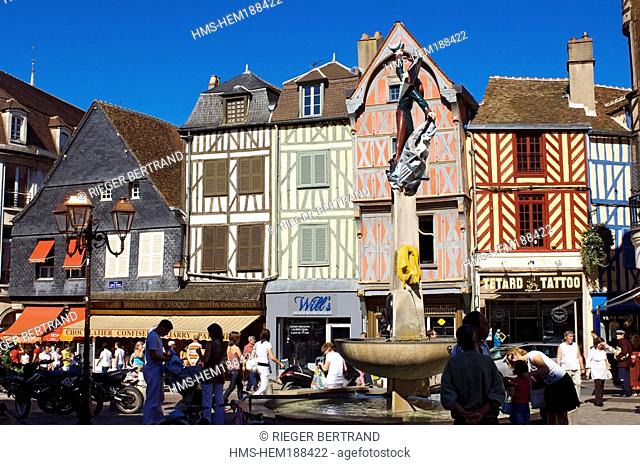France, Yonne, Auxerre, colorful façades at place Charles Surrugue and statue of Cadet Roussel