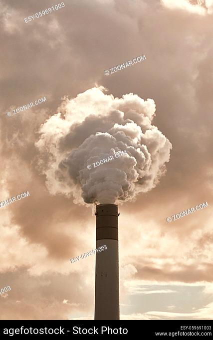 Smoking power plant chimney closeup
