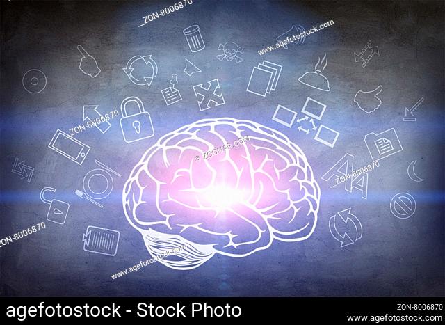 Drawn brain hovered over the human hand on the gray wall background