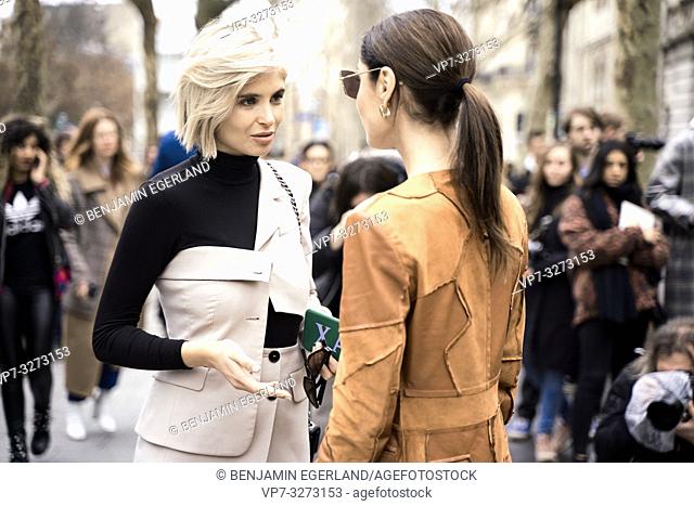 Street Style - Paris Fashion Week Womenswear Fall/Winter 2019/2020, Xenia Overdose (left) wearing a decorated cream blazer, black turtleneck top