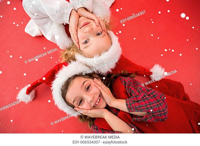 Composite image of festive little girls smiling at camera