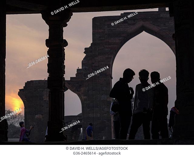 Silhouette of girls at Qutub Minar, New Delhi, India