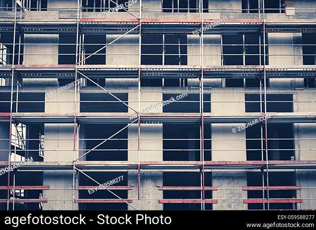 scaffolding on building facade under construction , frontal -