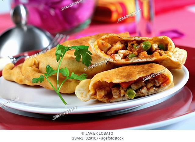 Empanadas pastries with fish filling opened