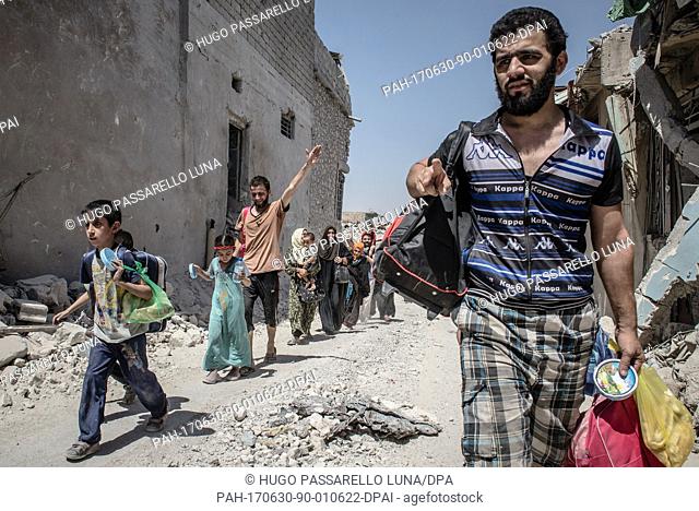 Iraqi civilians flee heavy fighting between Iraqi forces and the Islamic State in the Old City of Mosul, Iraq 29 June 2017