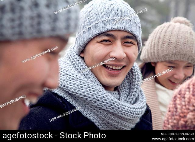 Portrait of Young Man in Winter with Friends