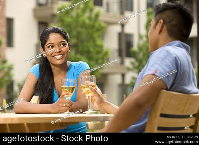 Couple drinking white wine outdoors
