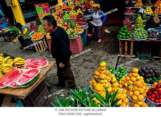 A Colombian vendor offers a freshly cut watermelon at the fruit market of Paloquemao in Bogota, Colombia, 25 November 2017. | usage worldwide