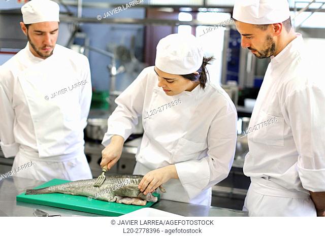 Chef cutting cod, Cook in cooking school, Cuisine School, Donostia, San Sebastian, Gipuzkoa, Basque Country, Spain, Europe