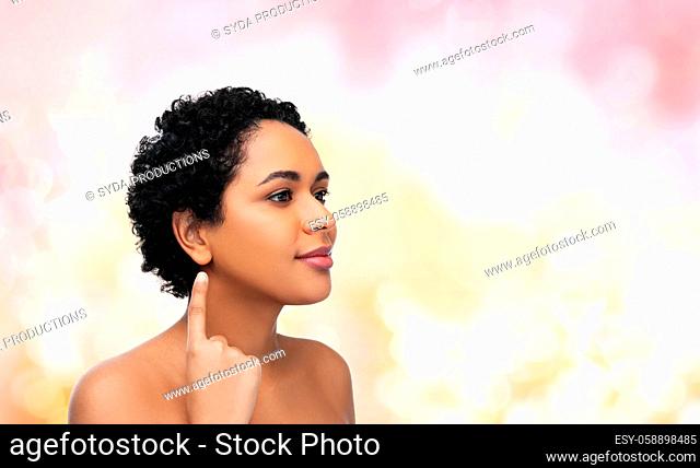 african american woman showing her ear