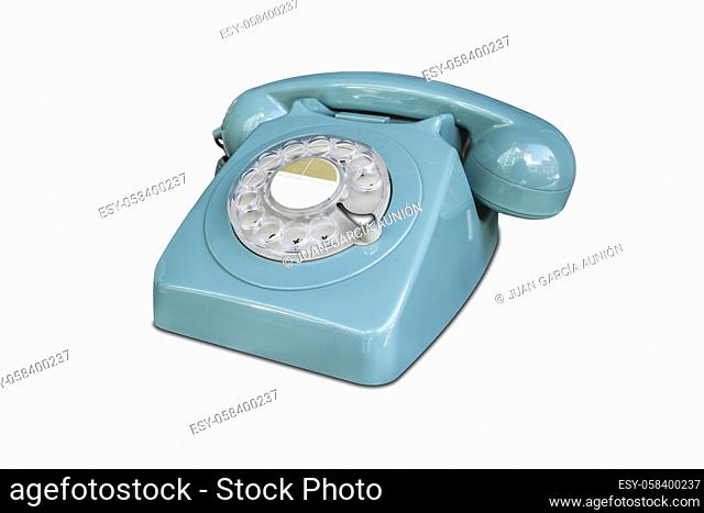 Turquoise rotary dial seventies telephone. Isolated over white